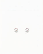 Pink sea pearl drop earrings in 18K gold from private collection with soft glowing pink luster