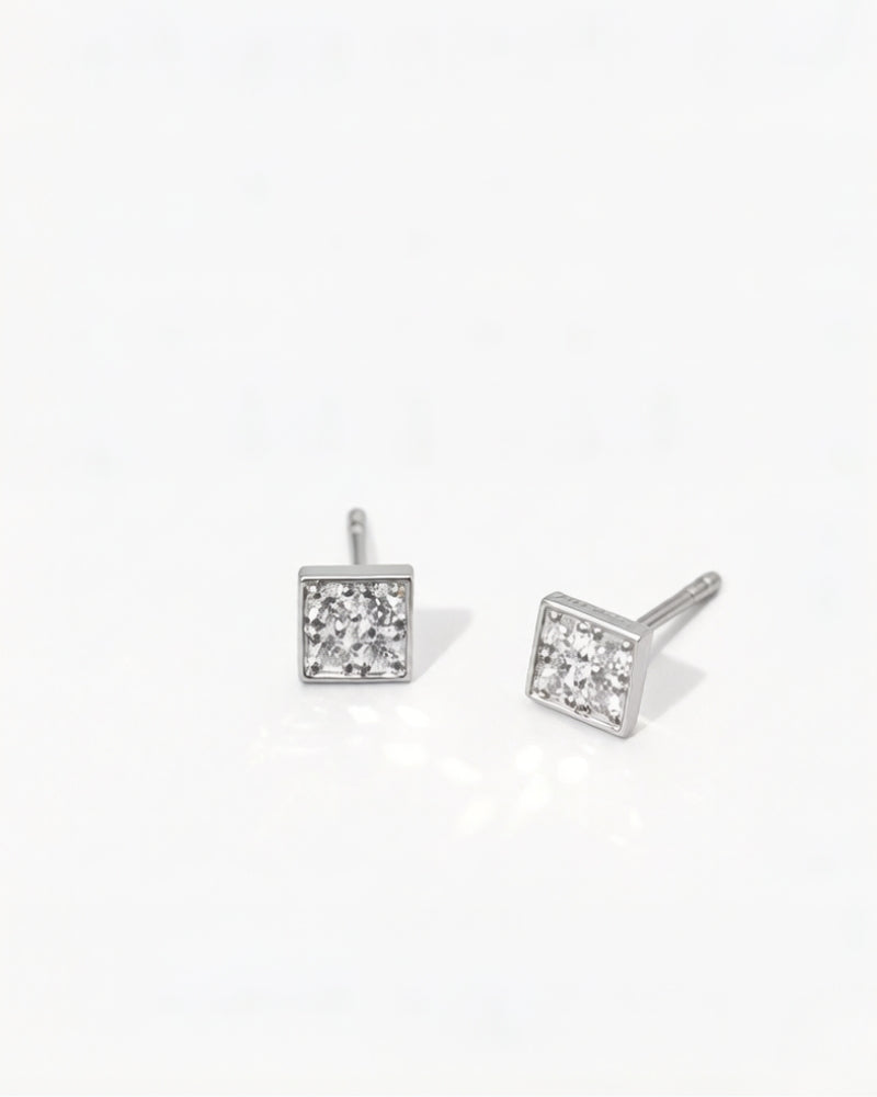 Detail of princess-cut detachable diamond stud earrings in solid 14K white gold