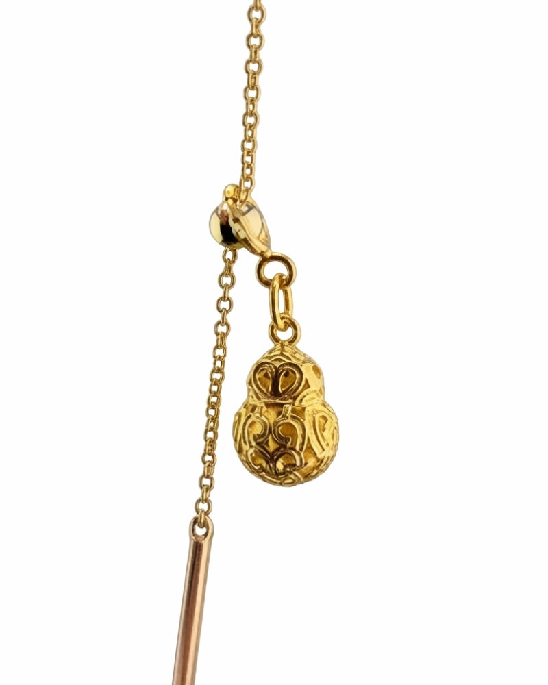 Long gold station necklace with small gourd charms, worn long