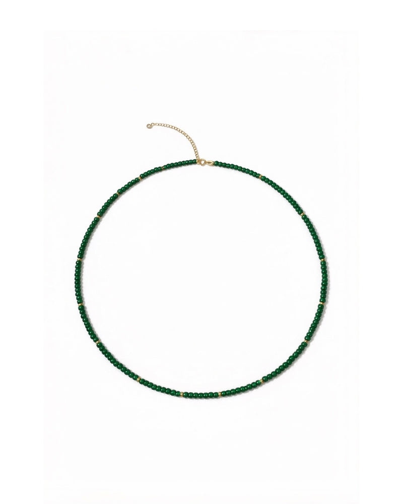 Green jade bead necklace with gold details, worn stacked and able to wrap around the wrist