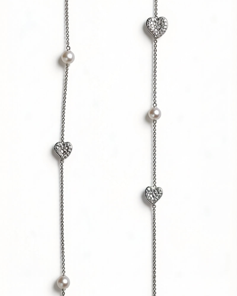 Front view of the Heart Akoya pearl and diamond long necklace with a curved calla-lily-like centre