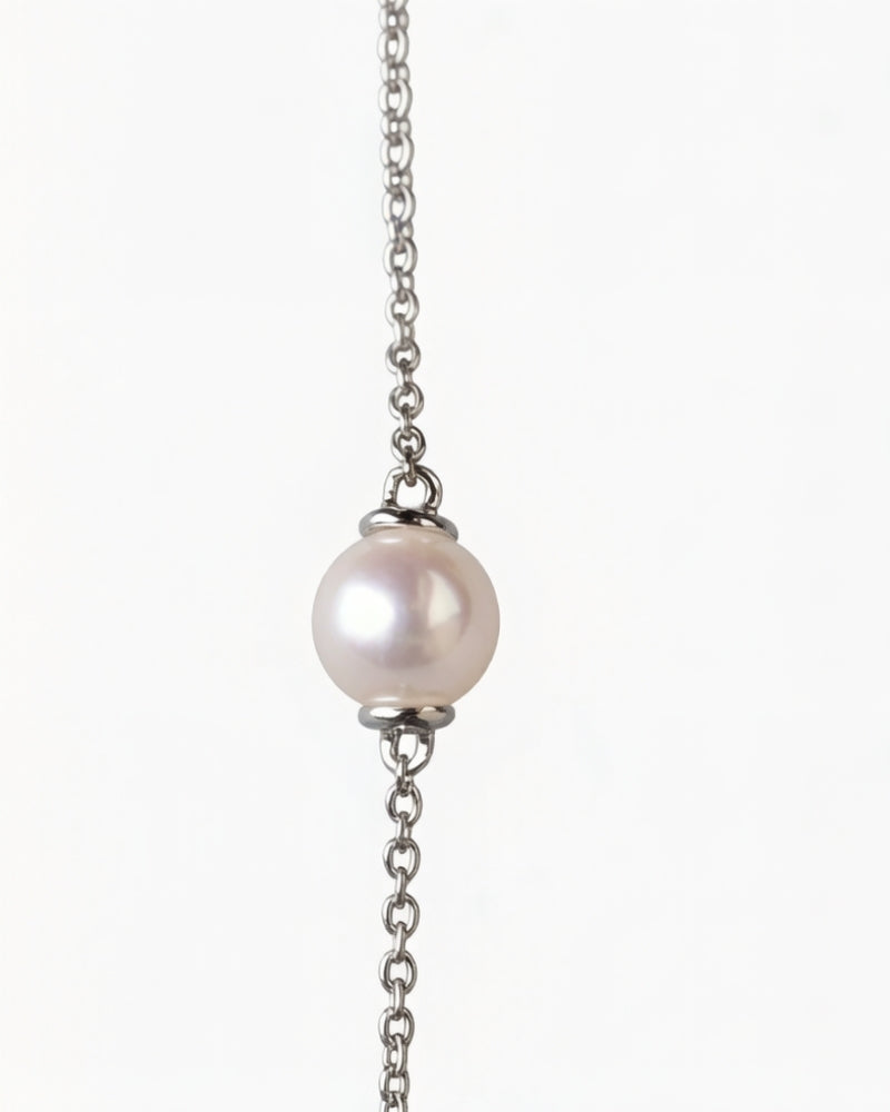 Side view of a long Akoya pearl and diamond necklace