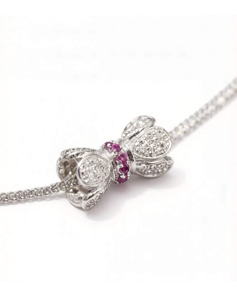 Pavé-set diamond bow pendant necklace in 18K white gold, front view