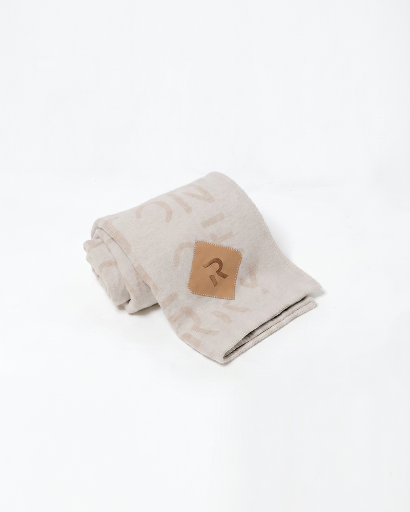 Oat cashmere wool blanket product shot with leather patch