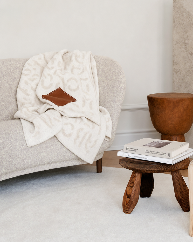 Oat cashmere blanket draped on modern sofa