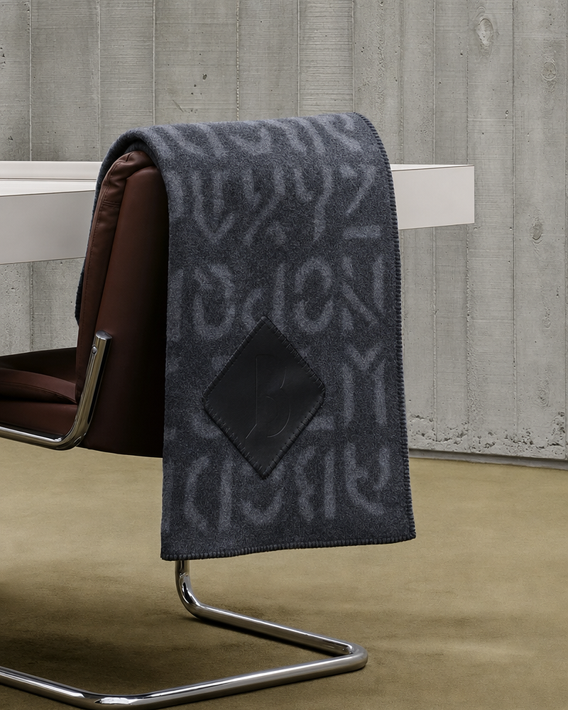 Grey cashmere blanket draped on chair