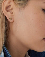 Solid gold stud earrings with ancient coin-inspired hammered texture in 18K gold