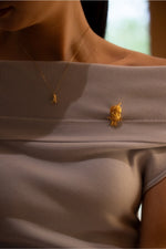 Model wearing Golden Parrot brooch on coat lapel, showcasing luxury styling-01