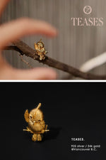 Side angle of handcrafted golden parrot brooch with natural black diamonds